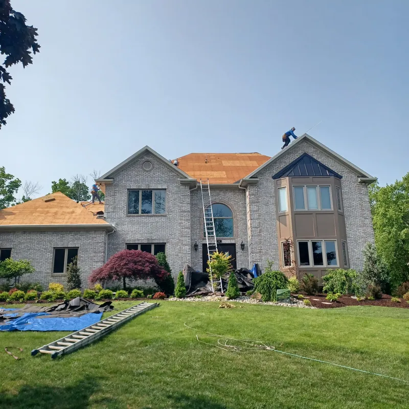 Two-story home with gray siding and wood accents, completed exterior renovation