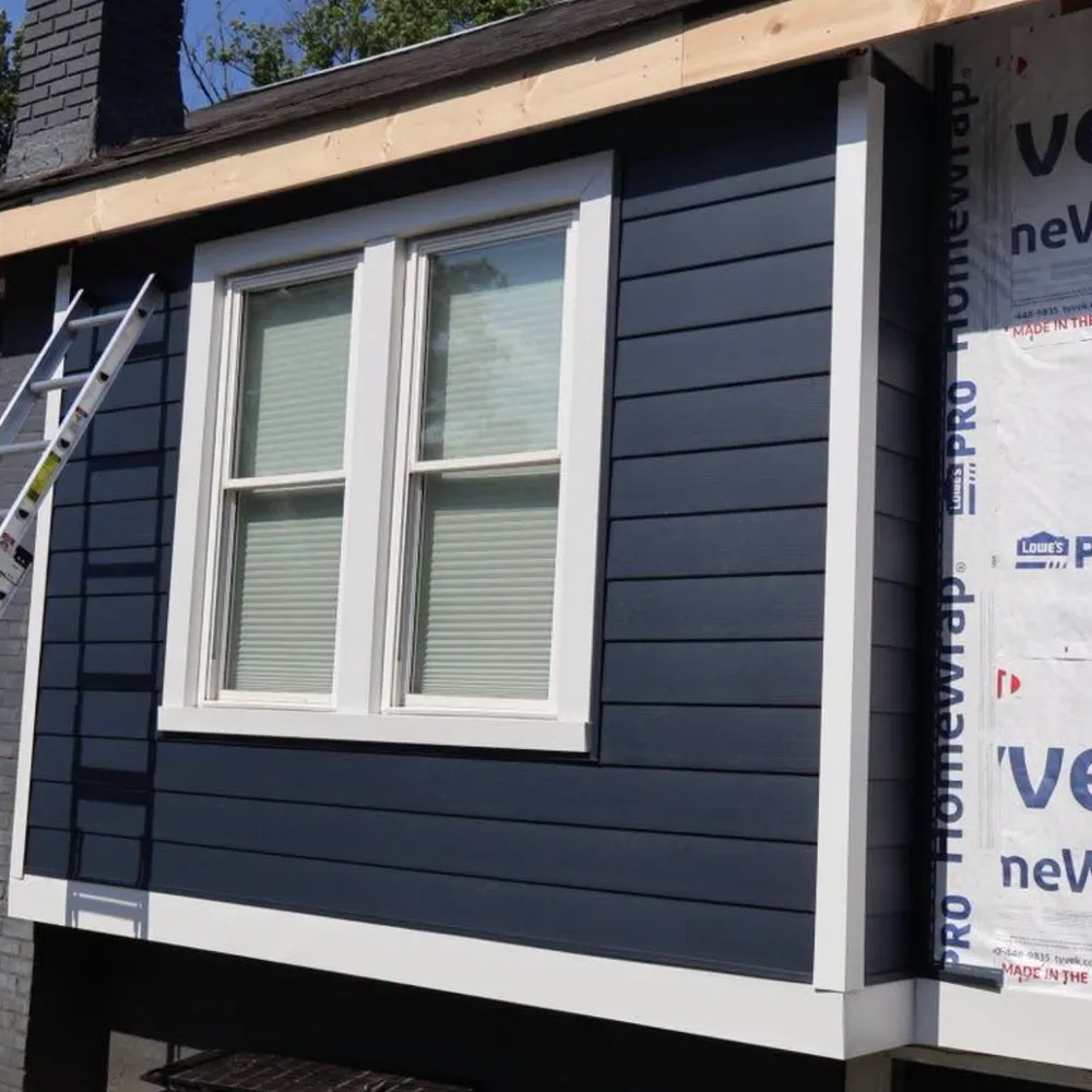 New navy blue horizontal siding installed