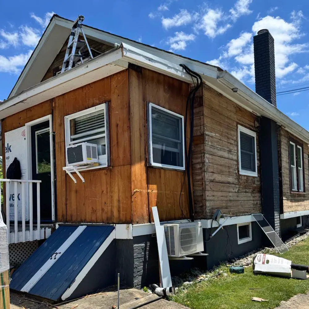 Original worn wood siding before replacement